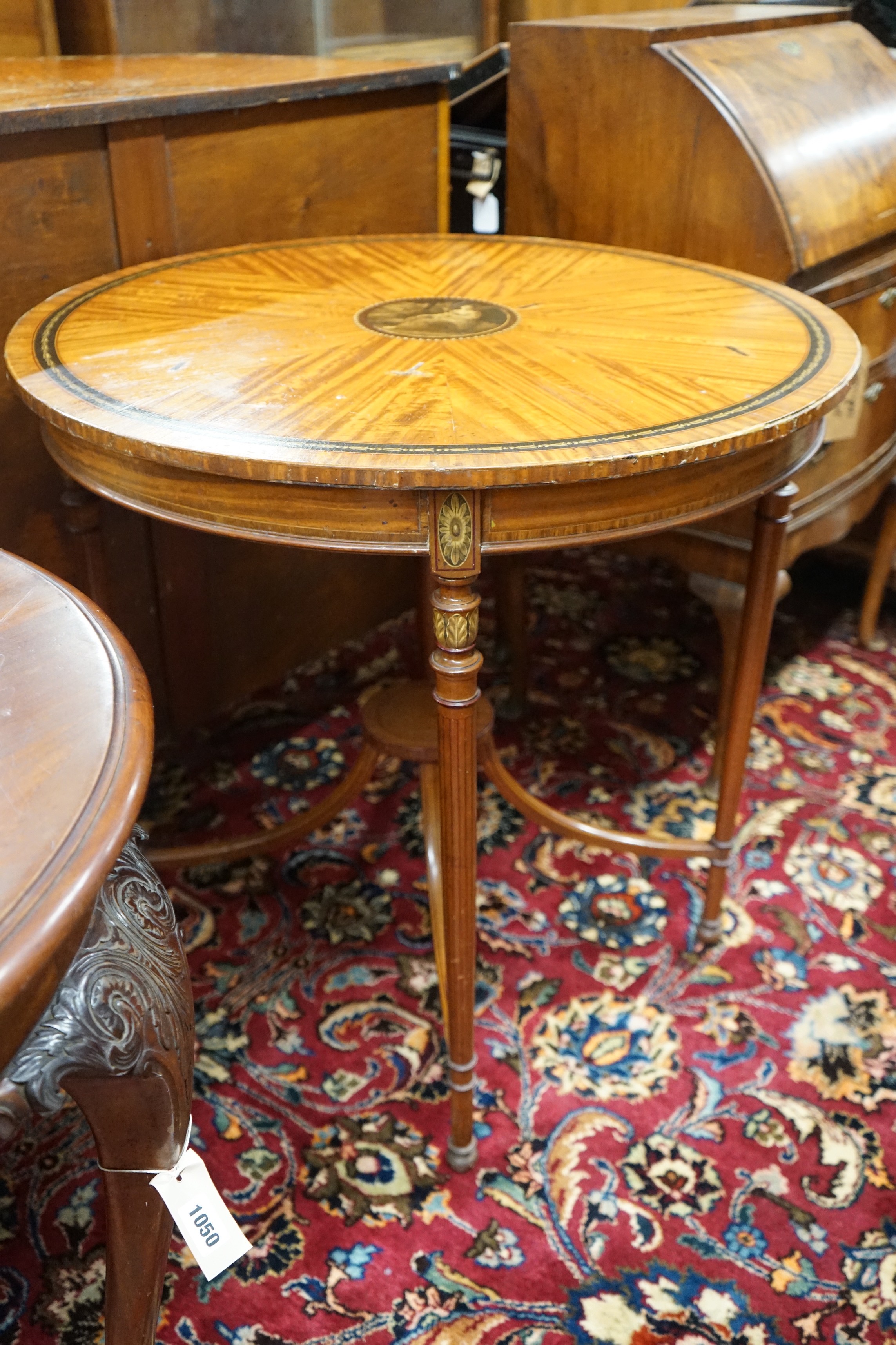 An Edwardian Sheraton revival circular painted satinwood centre table, diameter 76cm, height 77cm